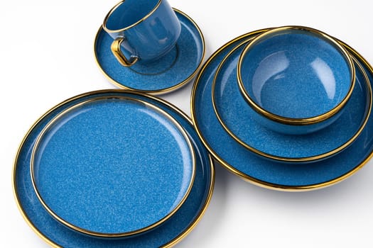 A set of blue ceramic plates and cup on a white background
