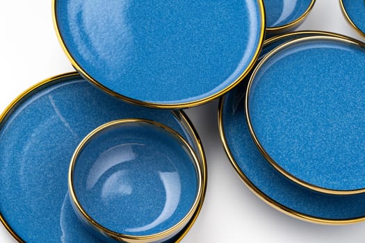 A set of blue ceramic plates on a white background. Top view