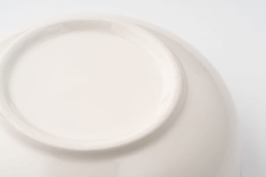 A closeup shot of the underside of a white bowl