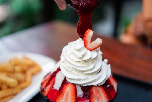 Bingsu or Bingsoo (Patbingsu) is a popular Korean shaved ice dessert with sweet toppings that may include chopped fruit, condensed milk, fruit syrup, and varieties with ingredients