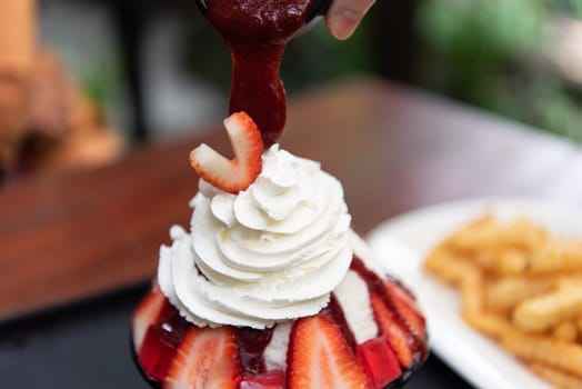 Bingsu or Bingsoo (Patbingsu) is a popular Korean shaved ice dessert with sweet toppings that may include chopped fruit, condensed milk, fruit syrup, and varieties with ingredients