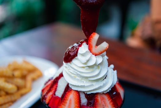 Bingsu or Bingsoo (Patbingsu) is a popular Korean shaved ice dessert with sweet toppings that may include chopped fruit, condensed milk, fruit syrup, and varieties with ingredients