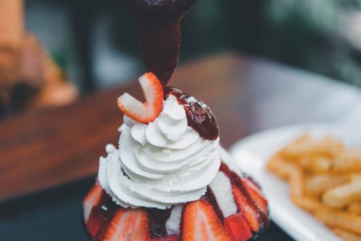 Bingsu or Bingsoo (Patbingsu) is a popular Korean shaved ice dessert with sweet toppings that may include chopped fruit, condensed milk, fruit syrup, and varieties with ingredients