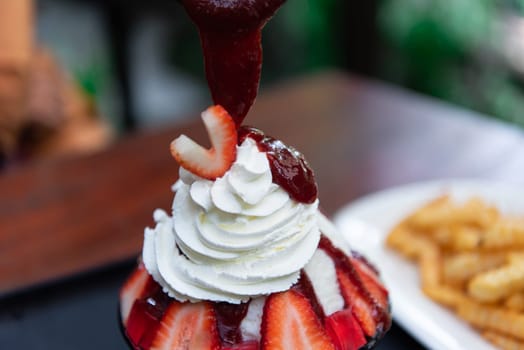 Bingsu or Bingsoo (Patbingsu) is a popular Korean shaved ice dessert with sweet toppings that may include chopped fruit, condensed milk, fruit syrup, and varieties with ingredients