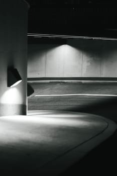 Vertical grayscale shot of the curved parking garage entrance in Duisburg, Germany.