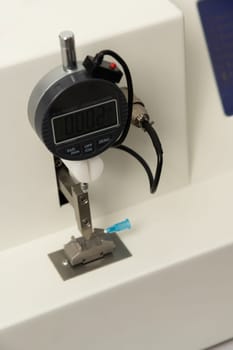 A vertical closeup shot of equipment in a medical laboratory for manufacturing medical syringes