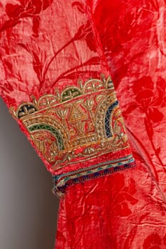 The decorative elements and ornaments on the Uzbekistan national robe sleeve