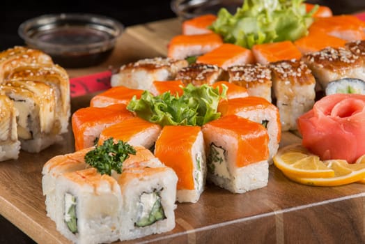 A closeup shot of a sushi set on a wooden plate