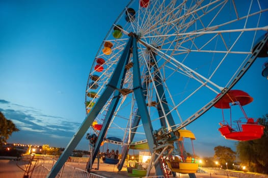 A attraction ferris wheel in the amusement park at night