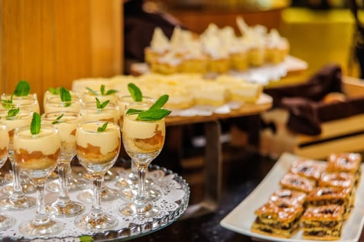 A closeup shot of a buffet table with desserts and sweets