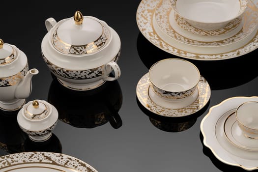 A luxury tableware set on black reflective surface