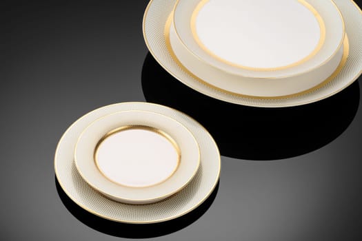 A luxury tableware set on black reflective surface