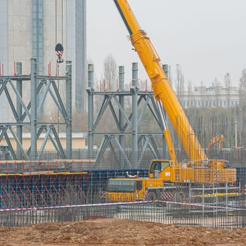 A track crane working in a industrial construction area