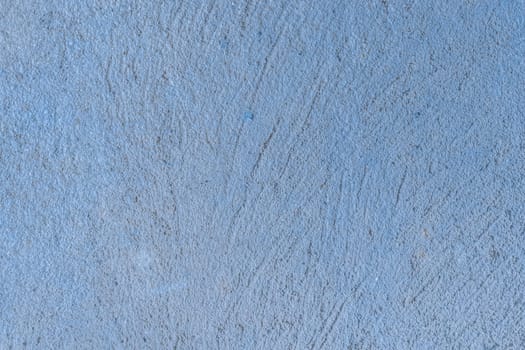 Old concrete wall worn cement background with abstract paint blue rough texture.