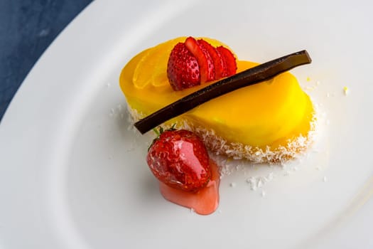 A closeup shot of a lemon cake with strawberries