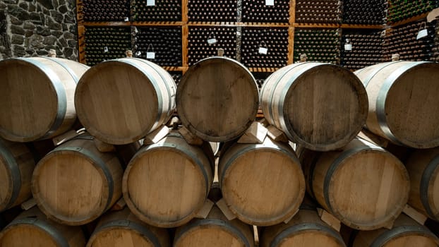 The wooden wine barrels with a wine cellar in the background