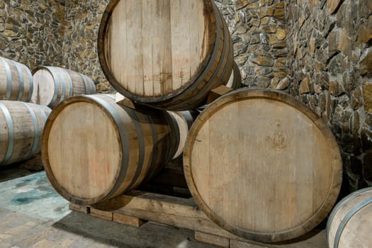 The wooden wine barrels in a wine factory