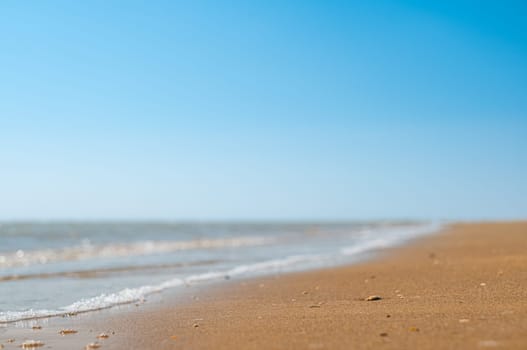 Closeup of sand on beach and blue summer sky. Panoramic beach landscape. Empty tropical beach and seascape