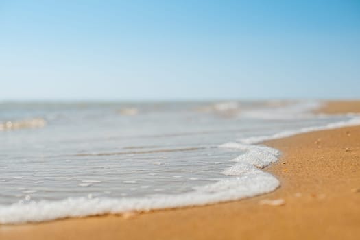 Closeup of sand on beach and blue summer sky. Panoramic beach landscape. Empty tropical beach and seascape