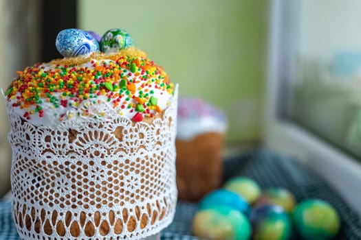 Easter cake with glace icing and decoration. Postcard with Easter bread. Christian traditions. Copy space. White background.