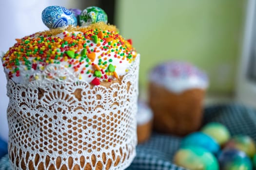 Traditional Easter cake with glace icing and painted easter eggs.Rustic style. Easter arrangement.