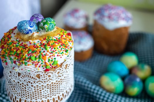 Traditional Easter cake with glace icing and painted easter eggs.Rustic style. Easter arrangement.