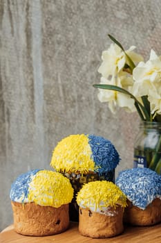 Delicious Easter cake and ingredients on wooden table.