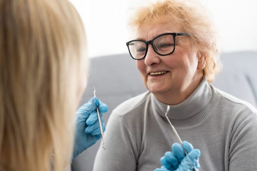 Close up portrait of elderly beautiful woman check up and having the consultation with dentist at the dental office