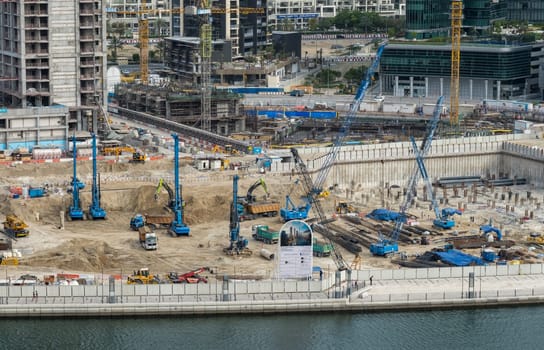 Dubai, UAE - April 1, 2023: Construction of new tower for apartments along canal in Business Bay