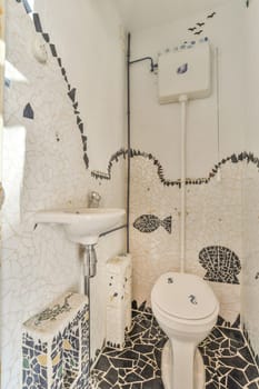 a bathroom with mosaic tiles on the walls and floor, including a toilet in the middle part of the room