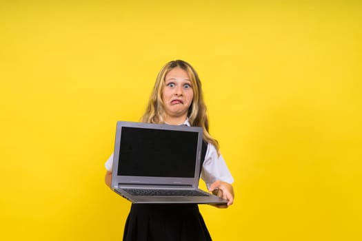 Little blonde kid girl on a pastel yellow wall background. Childhood lifestyle concept.