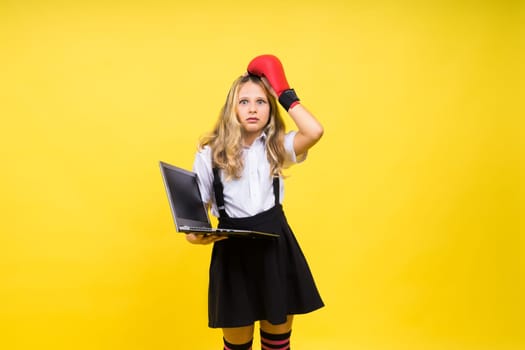 Little blonde kid girl on a pastel yellow wall background. Childhood lifestyle concept.