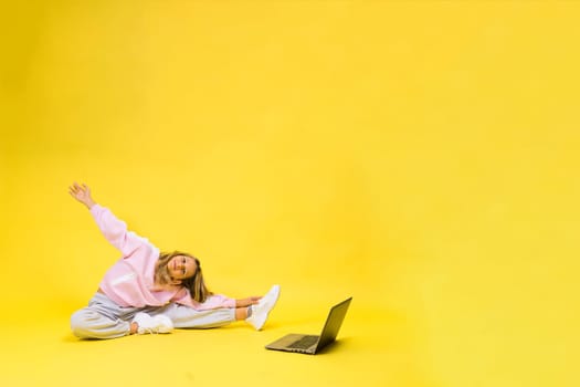 Little blonde kid girl on a pastel yellow wall background. Childhood lifestyle concept.