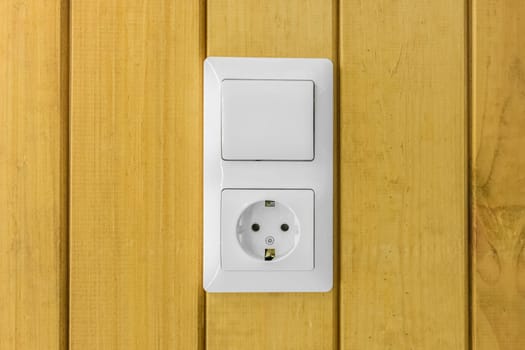 Power outlet connect plug voltage switch supply energy socket equipment electric appliance on color yellow wooden background.