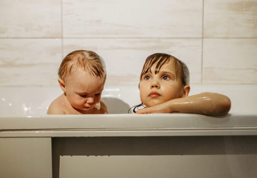 Preschool sister girls play in the bathroom.