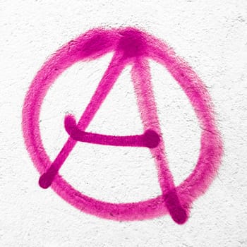 Pink anarchy symbol on wall. Ideal for textures, backgrounds and concepts. Copy space.