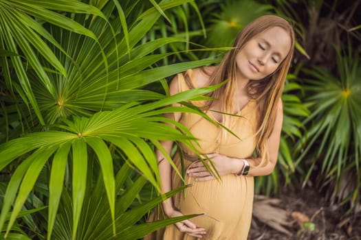 Pregnant woman walks in park at evening. Family enjoying pregnancy. The concept of Mother's Day and Women's Day.
