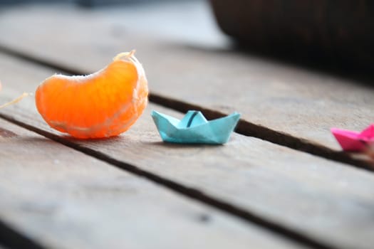 Summer time concept. Slice of tangerine on old vintage table.