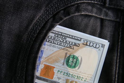 Dollars in a jeans pocket, closeup.