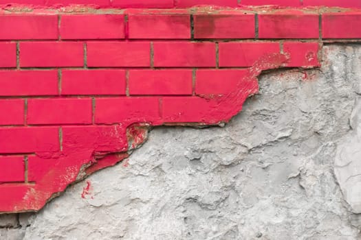 Red paint on brick broken masonry wall with cement white concrete damaged facade background texture.