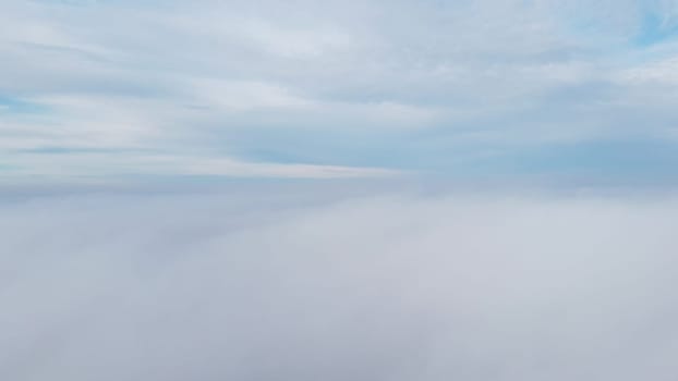 Sky clouds fog. Aerial drone view of blue sky and white clouds. View of fog from above and sky with clouds. Fog movement over city. View from above. Abstract natural background. Nature backdrop.