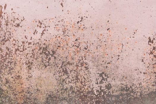 Light pink paint peeling off from the surface of the old metallic texture grunge steel background obsolete messy.
