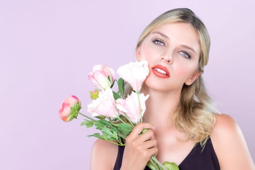 Closeup young woman with alluring flawless makeup and healthy skin holding rose for natural skincare treatment advertising in pink isolated background. Beautiful pretty model girl with flower concept.