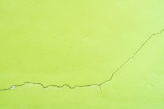 Green color with an old grunge wall concrete texture as a background.