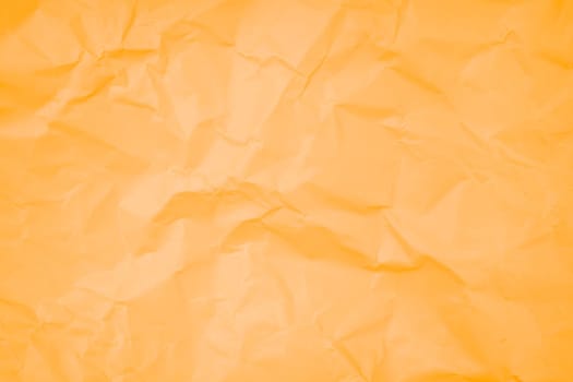 Abstract background from crumpled orange color paper texture.