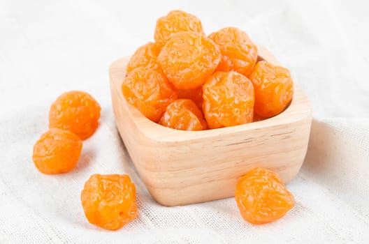 Reserved fruits or dried honey Chinese plum on wooden background