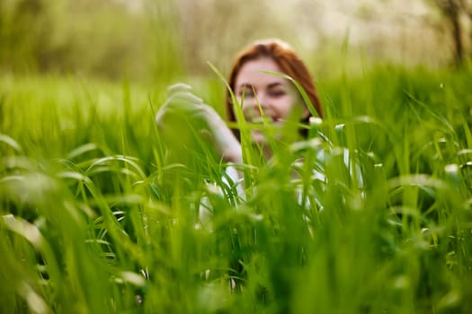 silhouette of a woman walking in tall grass. Photo out of focus. High quality photo