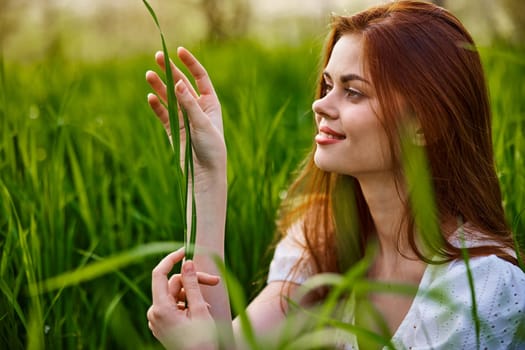 woman resting sitting in tall grass on a sunny day. High quality photo