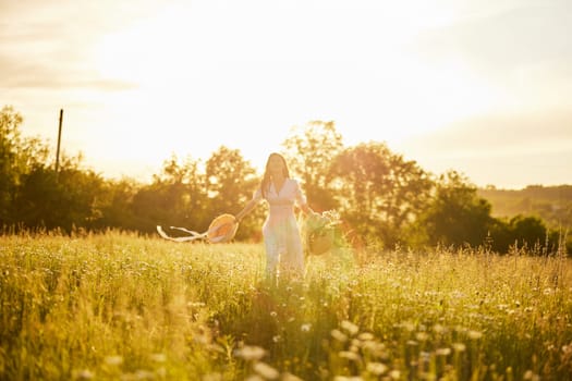 silhouette of a running woman in a light dress running across the field in the rays of the setting sun. High quality photo