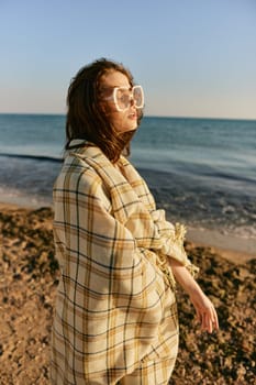 portrait of a woman with a plaid on a warm, sunny, summer day on the beach. High quality photo